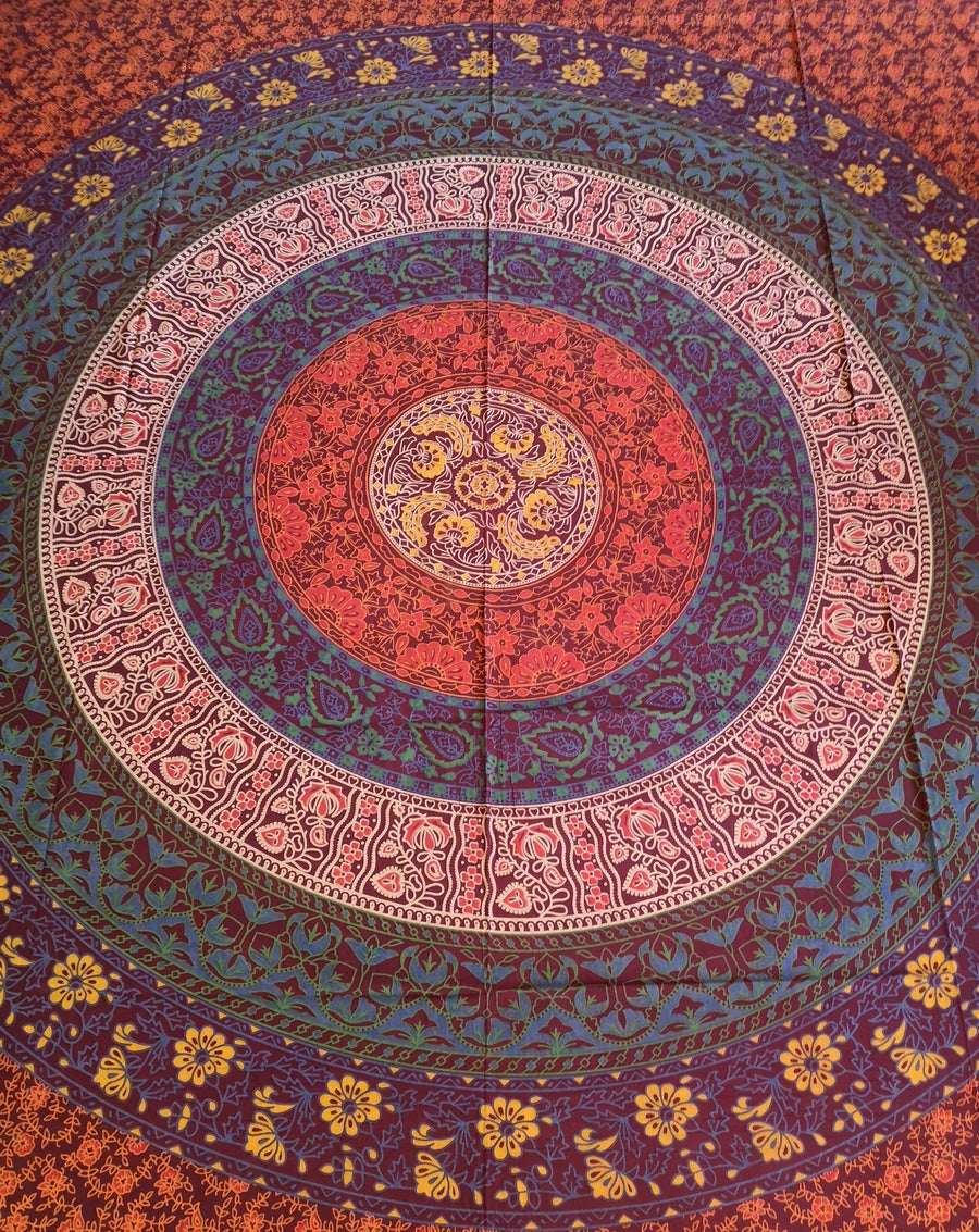 Magenta reds blues and turquoise circle with flowers indian tapestry, slightly closer
