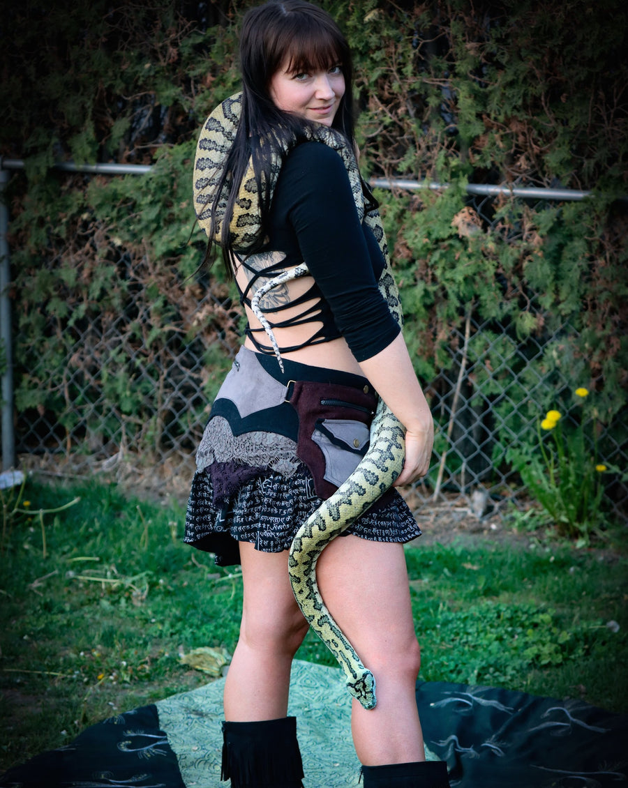 Billie looks great wearing the Arcane Coda Warrior Skirt and is holding a snake.