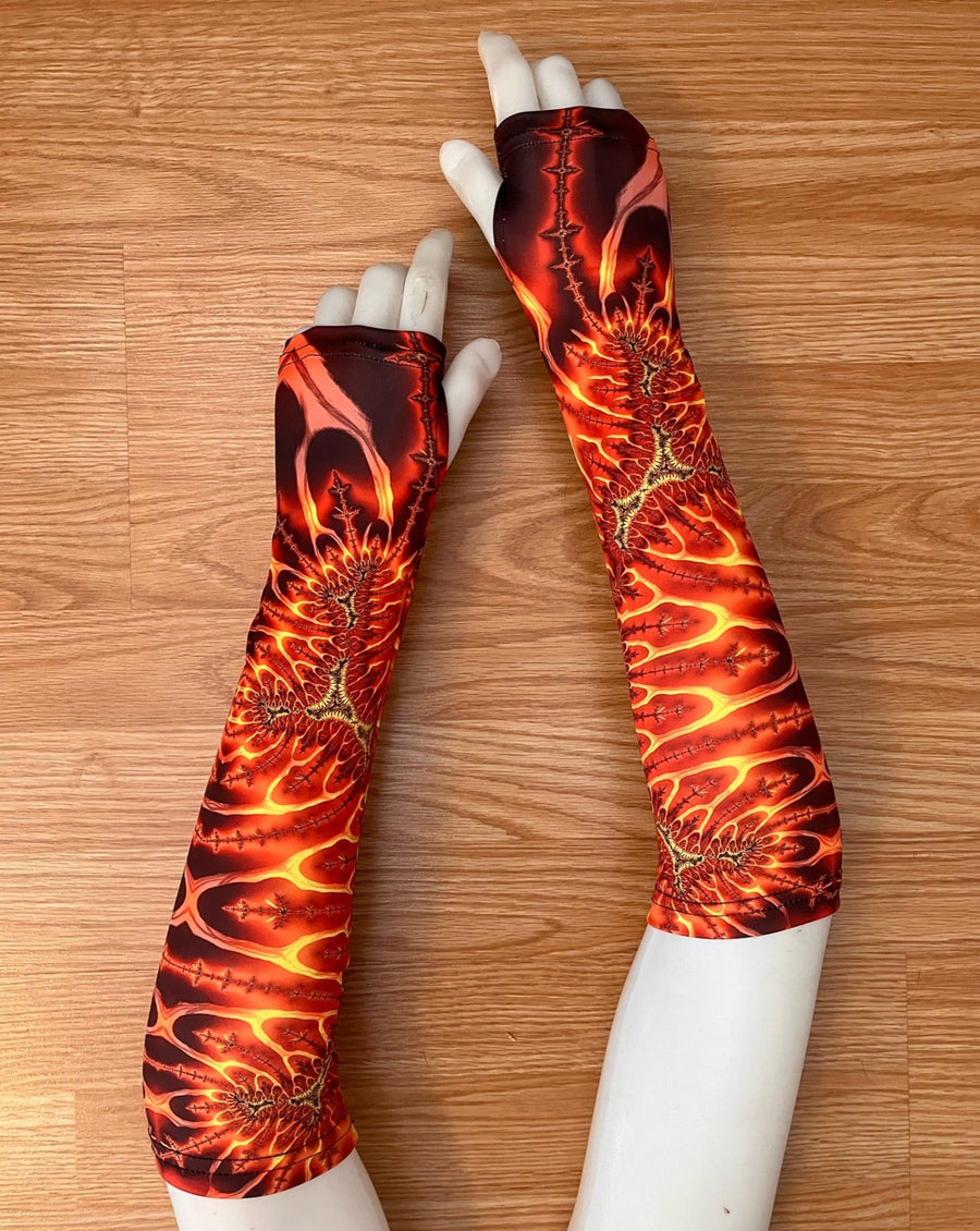 Mannequin hands lay on a laminate wood floor displaying colourful festival arms gauntlets.