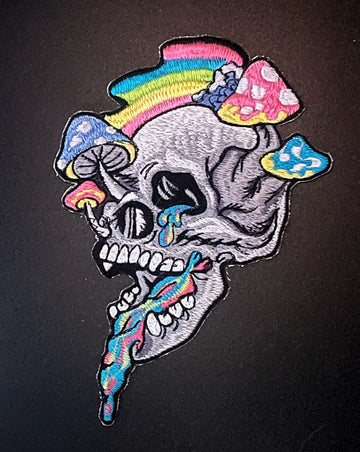 An embroidered patch shows what looks to be a melting skull with mushrooms growing out of it and colourful goo coming out of its mouth.